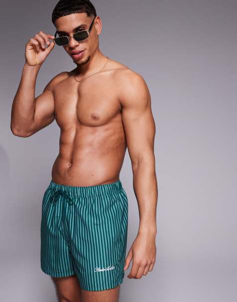 ASOS DESIGN swim shorts in short length in green stripe with placement print