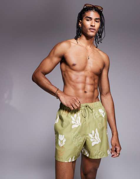 ASOS DESIGN swim shorts in short length with plant print in green