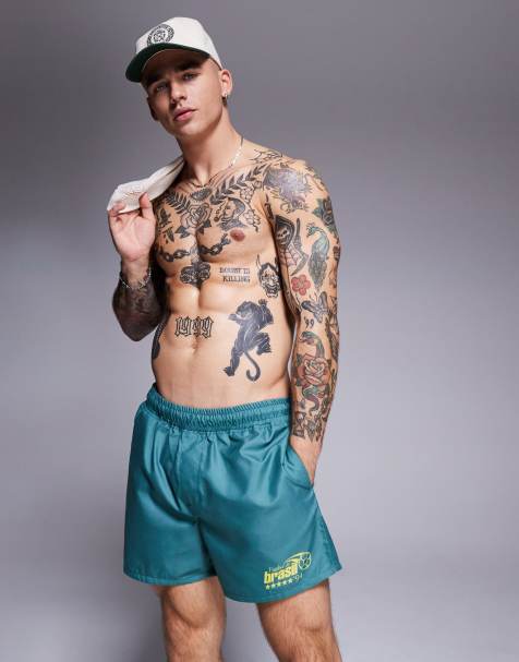 ASOS DESIGN swim shorts in short length with placement print in green