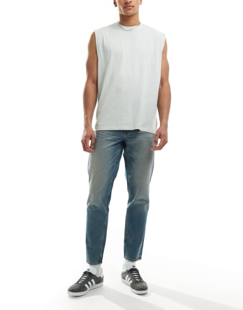ASOS DESIGN tapered fit jeans with tint in light wash blue