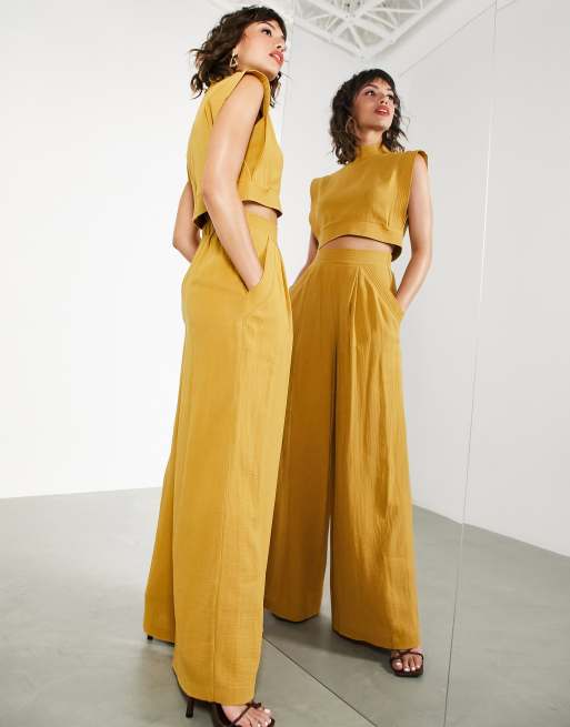 ASOS EDITION - Broek met wijde pijpen en gestikt detail in mosterdgeel