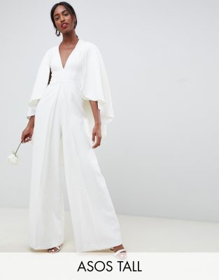 white jumpsuit with cape sleeves