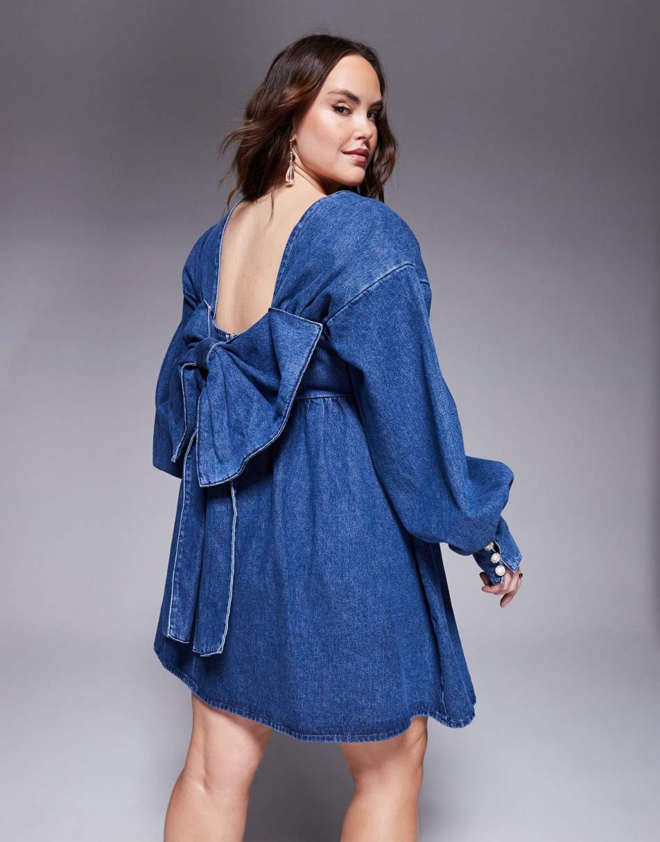 A plus-size denim mini dress with a low-cut back and large bow