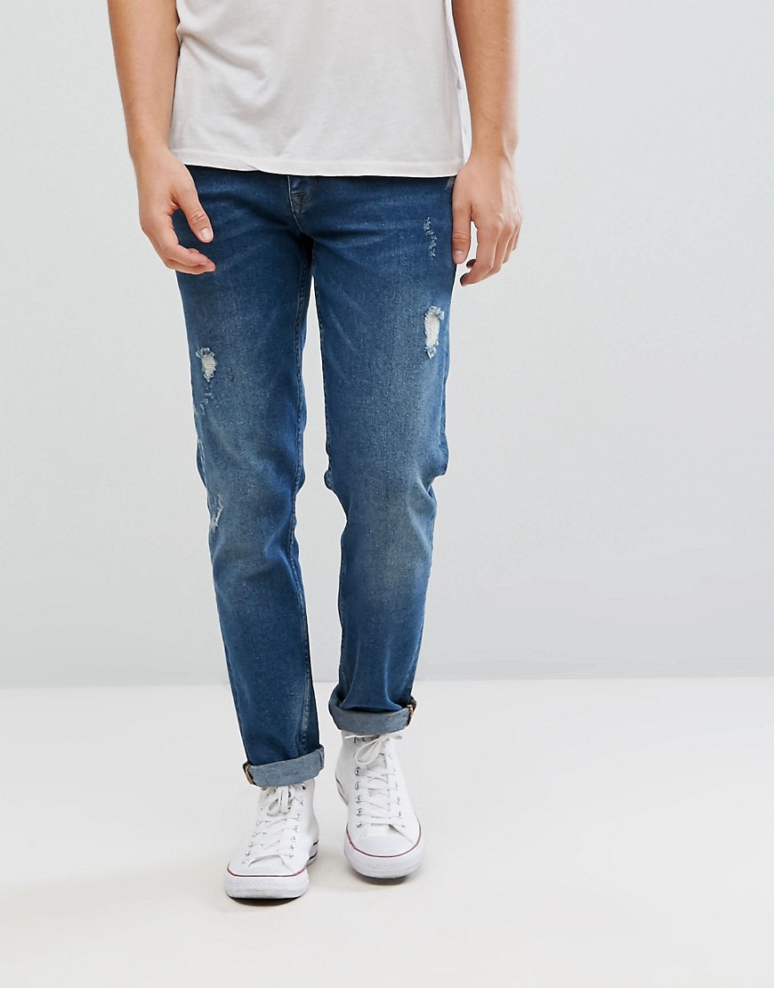 ASOS – Mörktvättade, slitna slim jeans i vintagestil-Blå