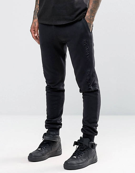 ASOS Skinny Sweatpants With Rips And Distressing In Black | ASOS