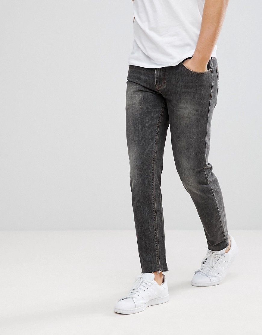 ASOS - Smalle stretch jeans met onafgewerkte zoom in zwart met wassing