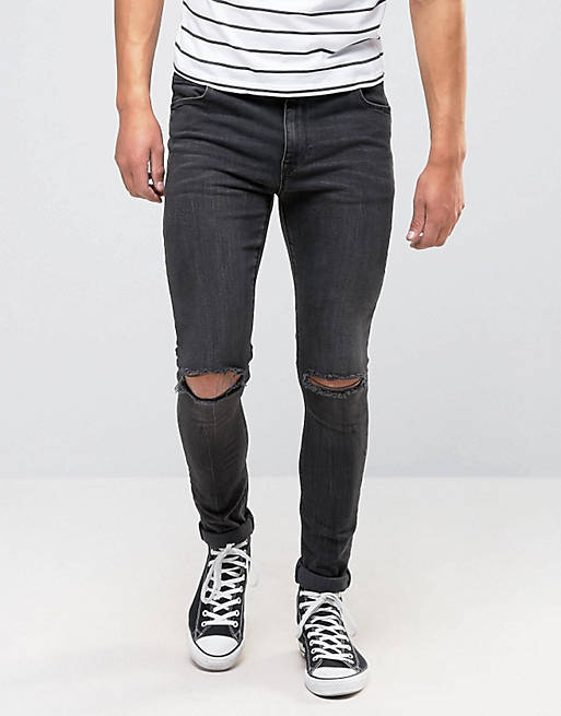 ASOS – Superenge Jeans mit Knierissen in verwaschenem Schwarz