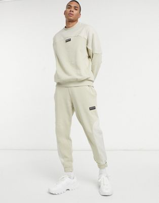 ASOS Unrvlld Spply co-ord tapered joggers in beige with nylon colour block panels
