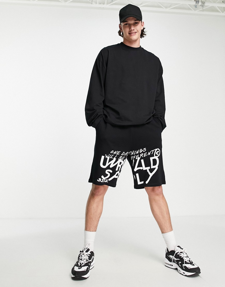 ASOS Unrvlld Spply oversized long jersey shorts with logo graffiti print in black