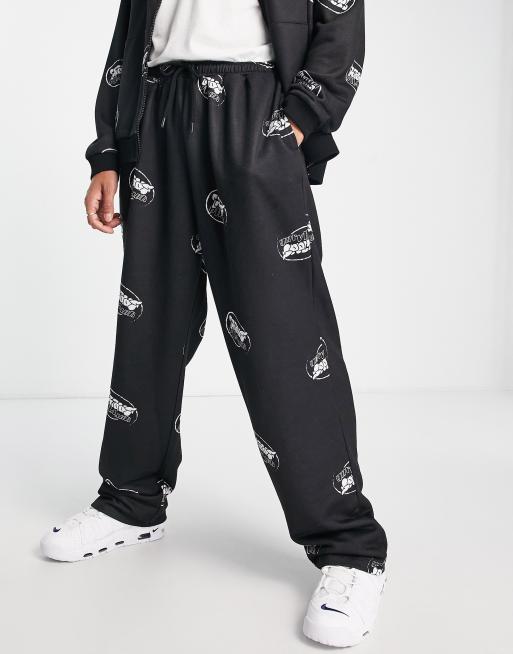 ASOS Unrvlld Spply oversized low-rise sweatpants with all over logo print  in black - part of a set