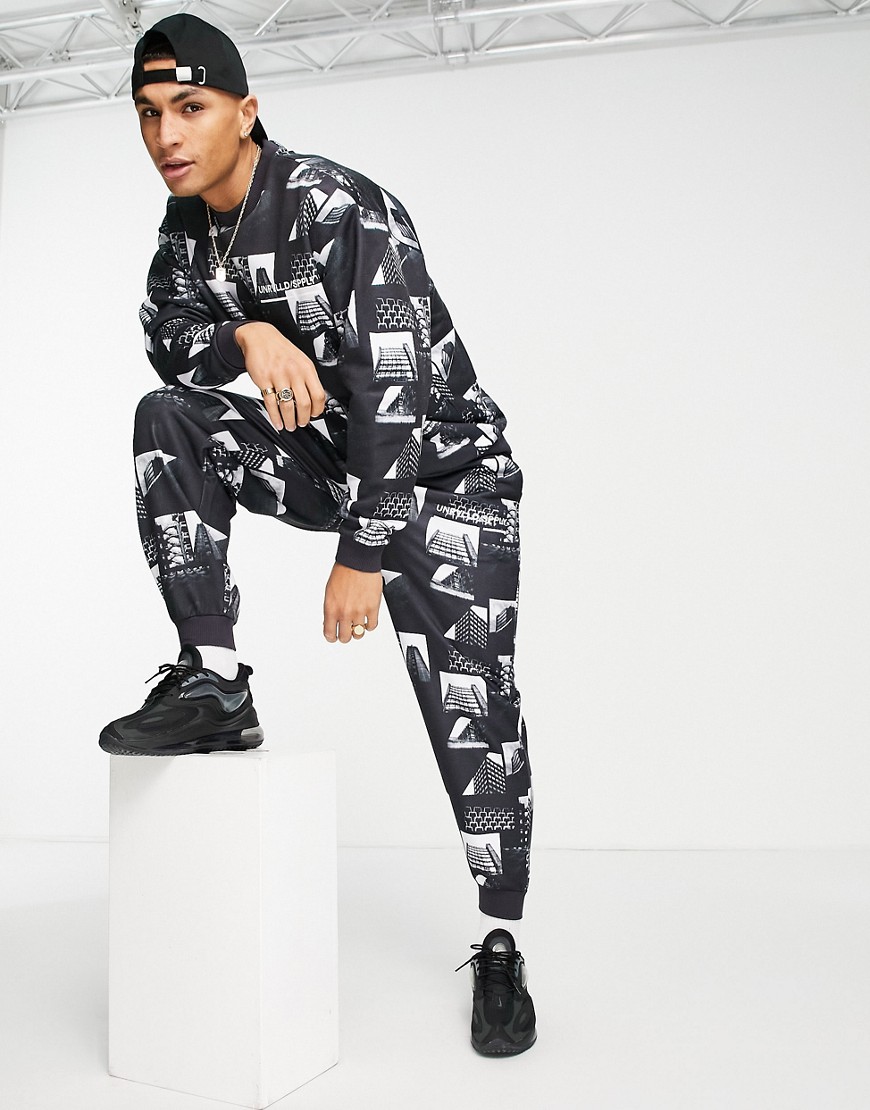 ASOS Unrvlld Spply tracksuit with all over photographic design & logo print-Black