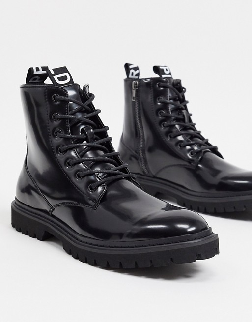 ASOS Unrvlld Supply lace up boots in black patent faux leather with tape detail