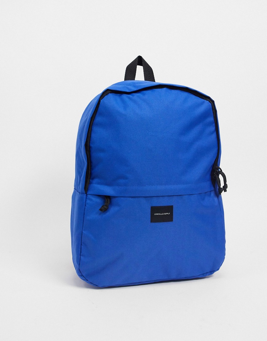 ASOS – Unrvlld Supply – Liten koboltblå ryggsäck med märke med logga