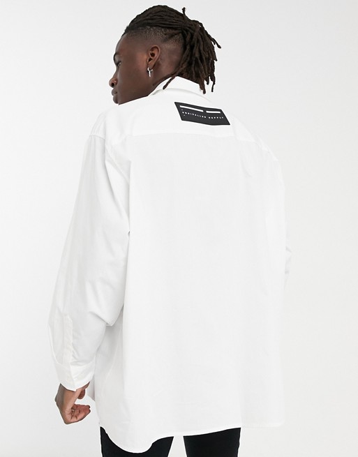 ASOS Unrvlld Spply super oversized white poplin shirt with rubberised badge logo