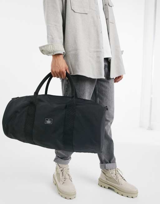 ASOS Unrvlld Supply – Torba na siłownię z czarnego nylonu o pojemności 37 litrów, z paskiem na ramię