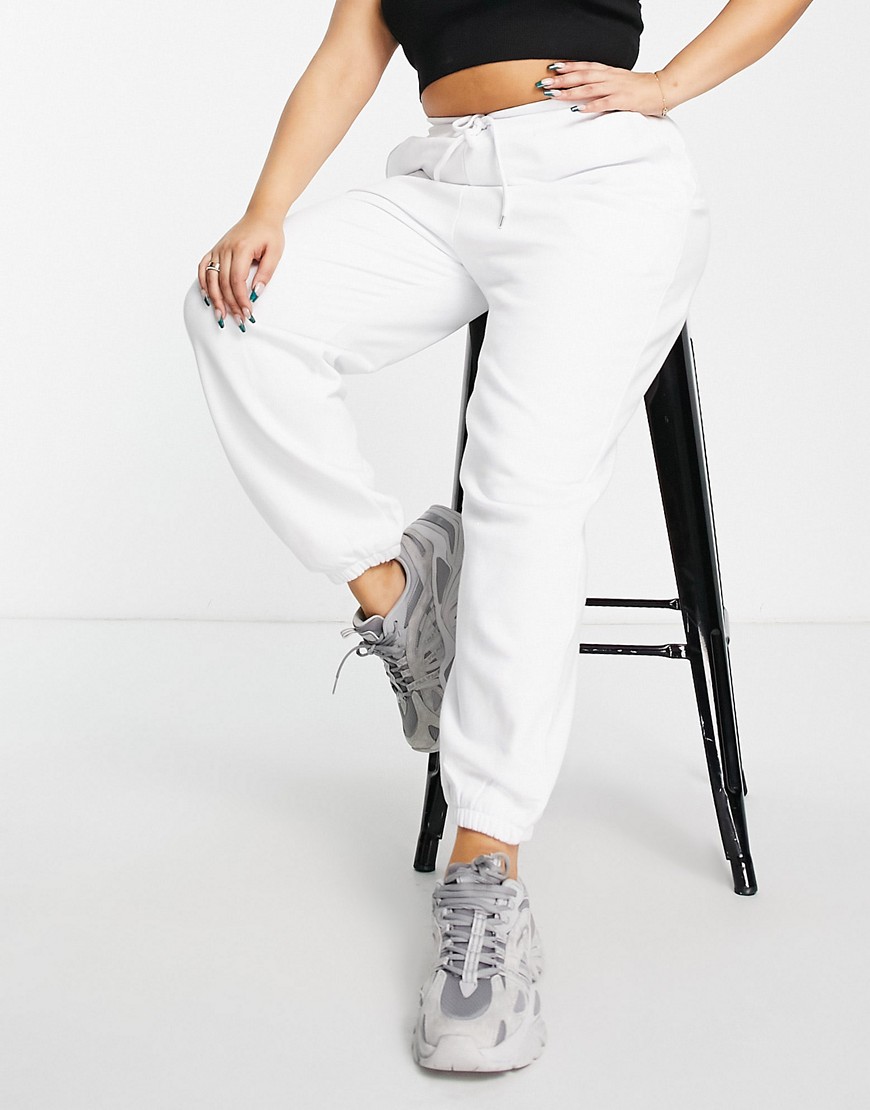 Plus-size joggers by ASOS DESIGN Part of our responsible edit Elasticated drawstring waist Side pockets Logo detail to thigh Elasticated cuffs Oversized, tapered fit