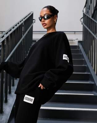 ASOS Weekend Collective oversized sweatshirt with large back logo in black