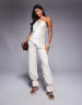 ASOS X THE SOURCED COLLECTION satin asymmetric cami top with trim detail in cream