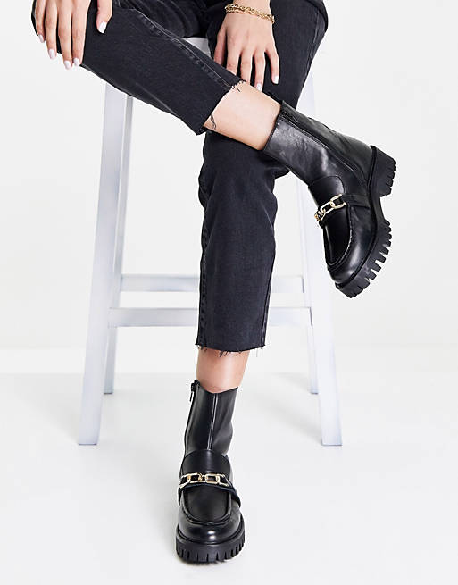 ASRA Bobbie chunky flat boots with gold chain in black leather