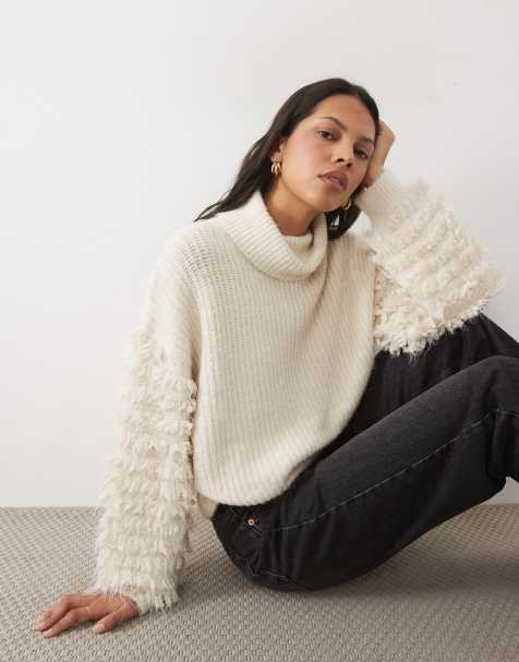 AWARE jersey de cuello alto con detalle de volantes en las mangas en color crema - view 1