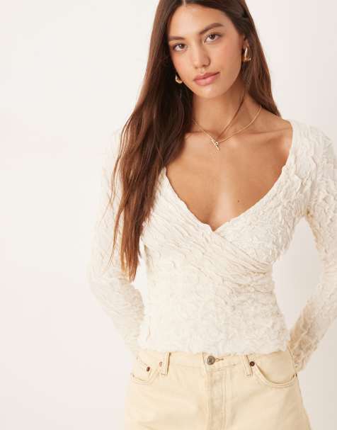 AWARE stretchy jaquard knit bell sleeve wrap detail top in cream 