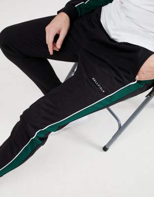 black joggers with green stripe