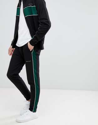 black joggers with green stripe