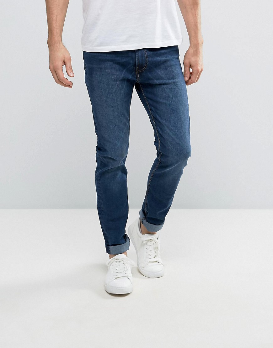 bellfield - stentvättade jeans med avsmalnande passform-blå