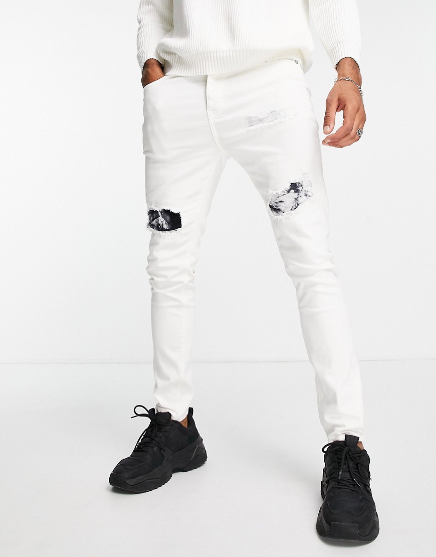 фото Белые зауженные джинсы с разрезами и заплатками с принтом тай-дай черного цвета sixth june-белый