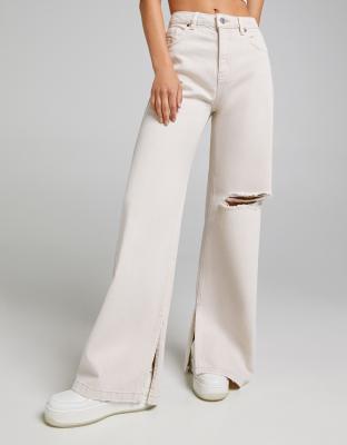 Bershka - Broek met wijde pijpen en scheur op de knie in beige | ASOS