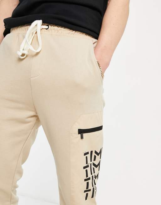 Bershka cargo joggers with printed pockets in tan