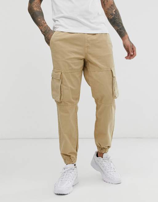 Bershka cargo pants with pocket detail in beige | ASOS