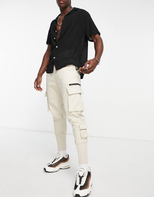 Bershka cargo pants with pockets in beige | ASOS