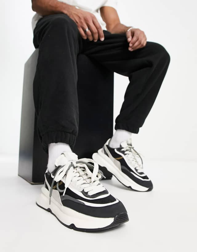 Bershka chunky running sneakers in black & white