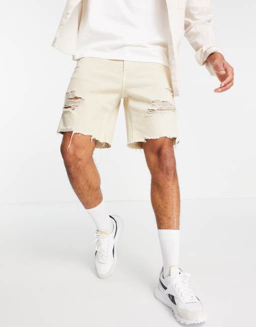 Bershka distressed denim shorts in beige ASOS