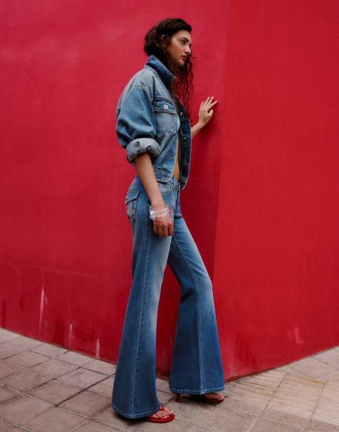 Bershka Embroidered low-rise flared jeans in mid blue