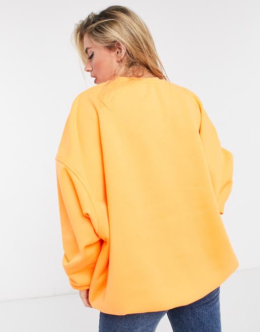 ASOS DESIGN oversized sweatshirt in neon orange