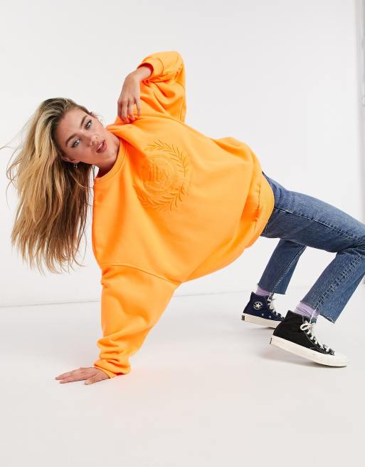 Bershka embroidered slogan oversized sweatshirt in orange