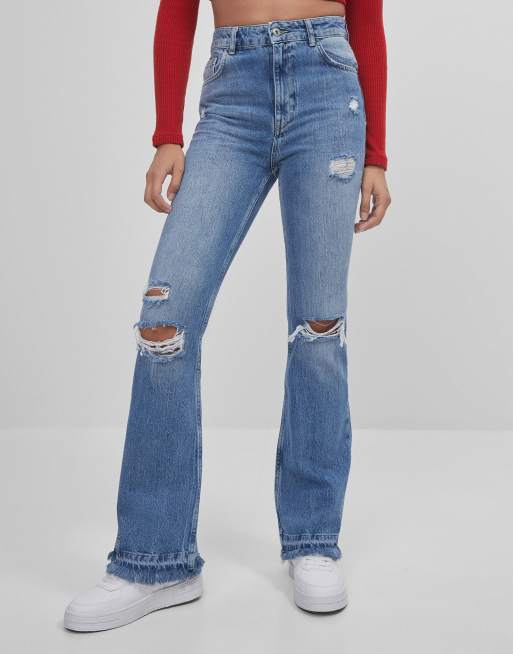 Bershka flare jeans with rips in blue