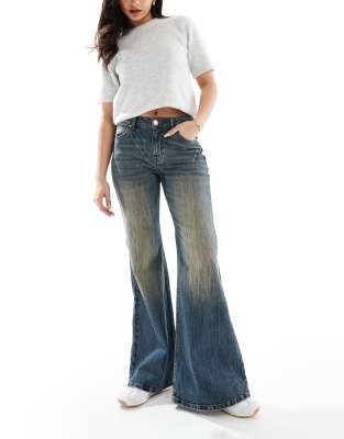 flared jeans in dirty wash blue