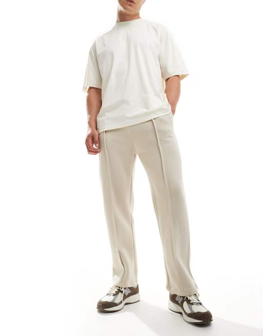 Bershka - Joggingbroek met platgestikte plooi en wijde pijpen in beige