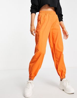 Bershka nylon cargo parachute trousers in orange
