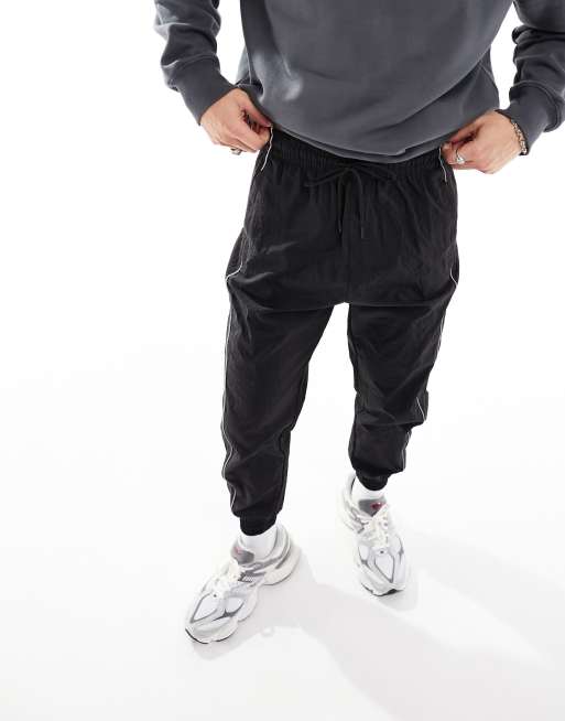 Bershka nylon piped parachute trouser in black