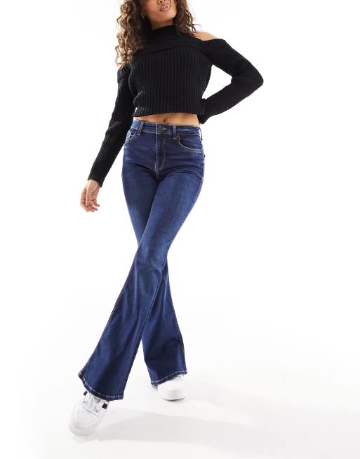 Bershka Petite high waisted flared jeans in indigo wash