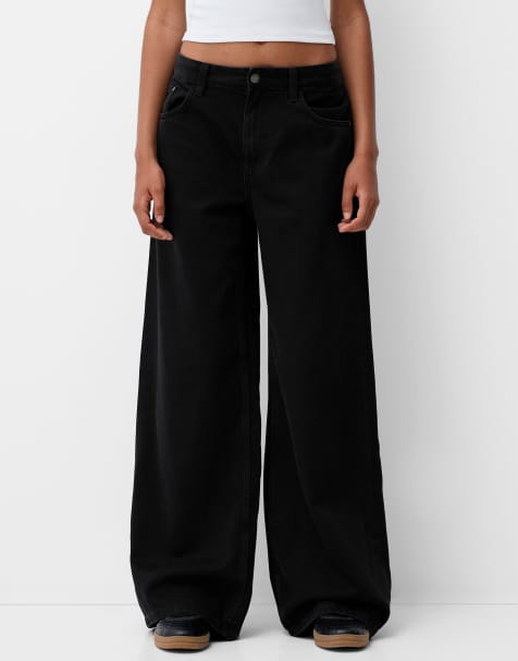 Bershka Petite - Jeans met wijde pijpen in zwart - view 1