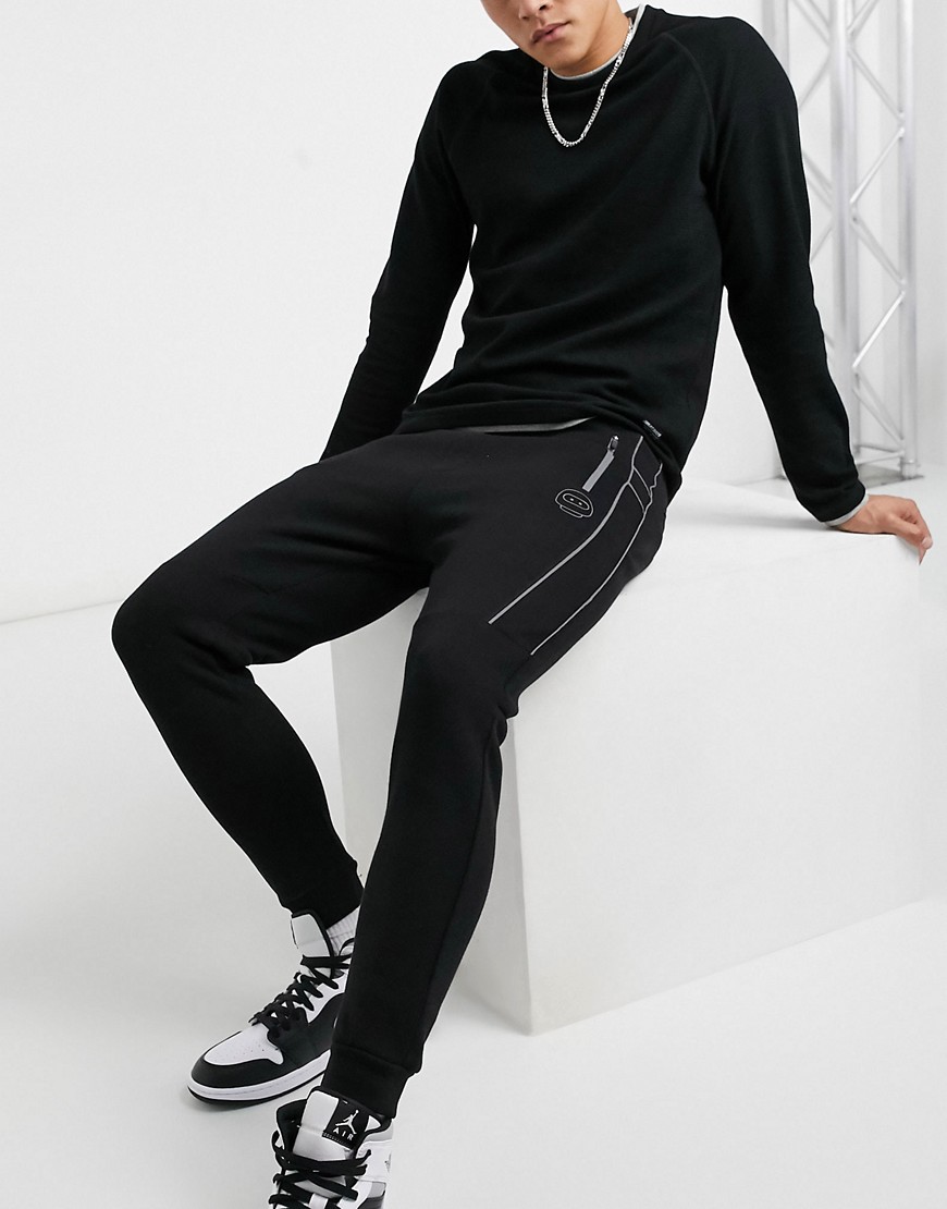 Bershka - Piqué joggingbroek in zwart met reflecterende biezen