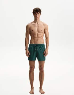 Bershka plain swimming trunks in green - view 1