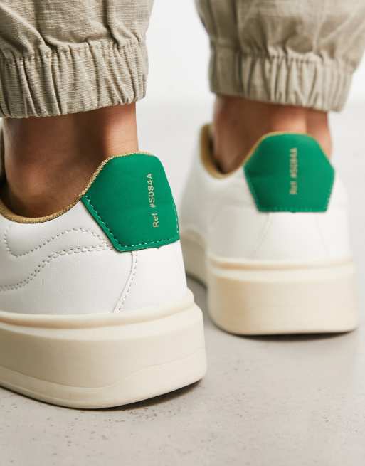 White sneakers store with green back