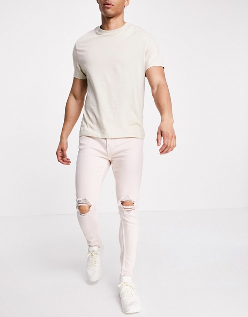 Bershka skinny fit jeans with rips in washed pink