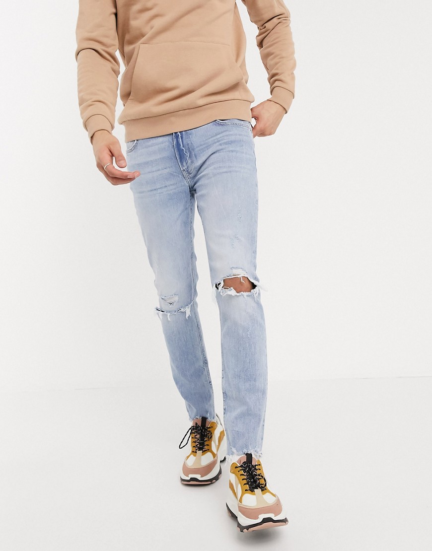 Bershka skinny jeans with knee rips in light blue wash